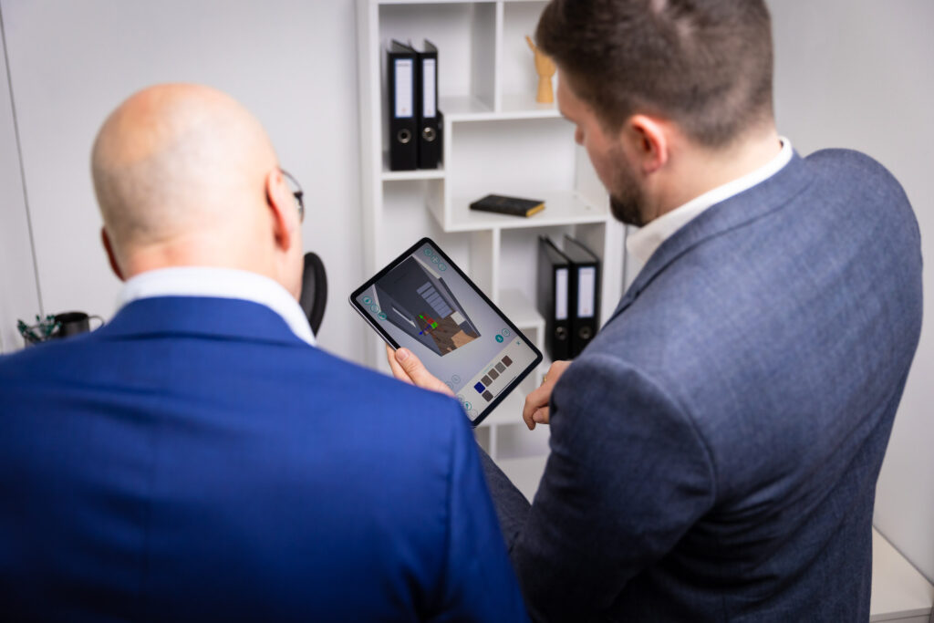 Two men looking at a tablet